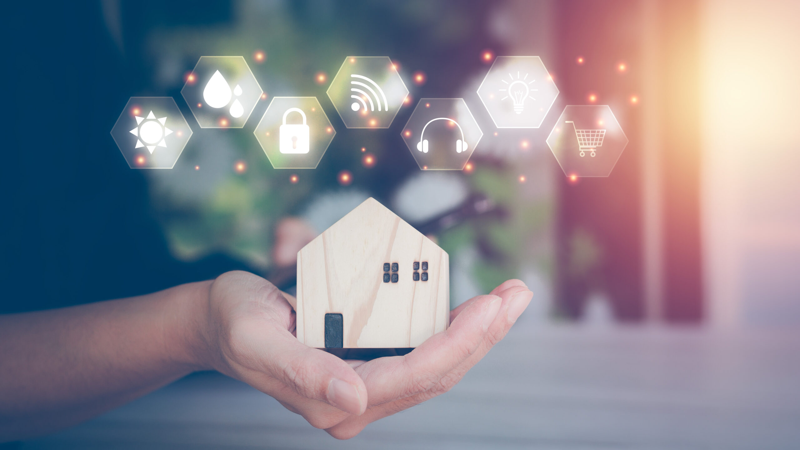 Smart home concept. Businessman holding small wooden house model in hand and virtual screen and icon, future home, internet home control. and applications, artificial intelligence.
